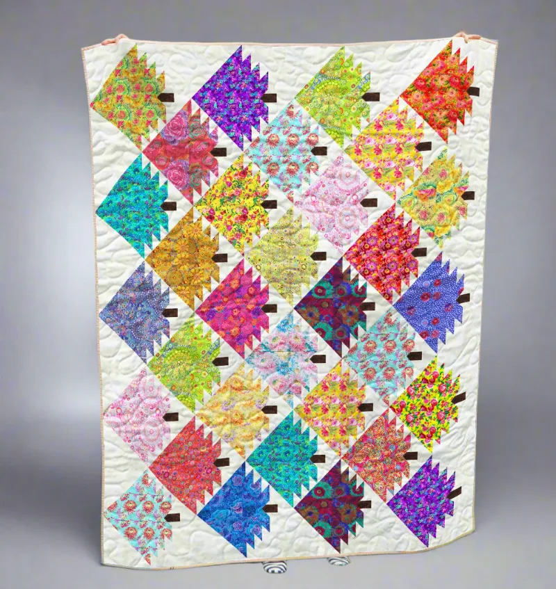 Boho Blanket Kaleidoscope Garden Quilt Pattern, cover showing a bold tree-ring inspired quilt design
