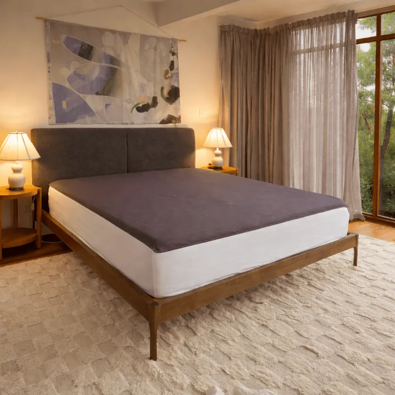 Premium Grounding Sheets on bed with white pillows