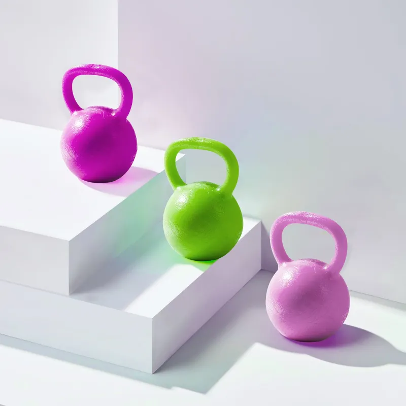 Vitos Kettlebell Therapy Ball in hand showing textured grip surface