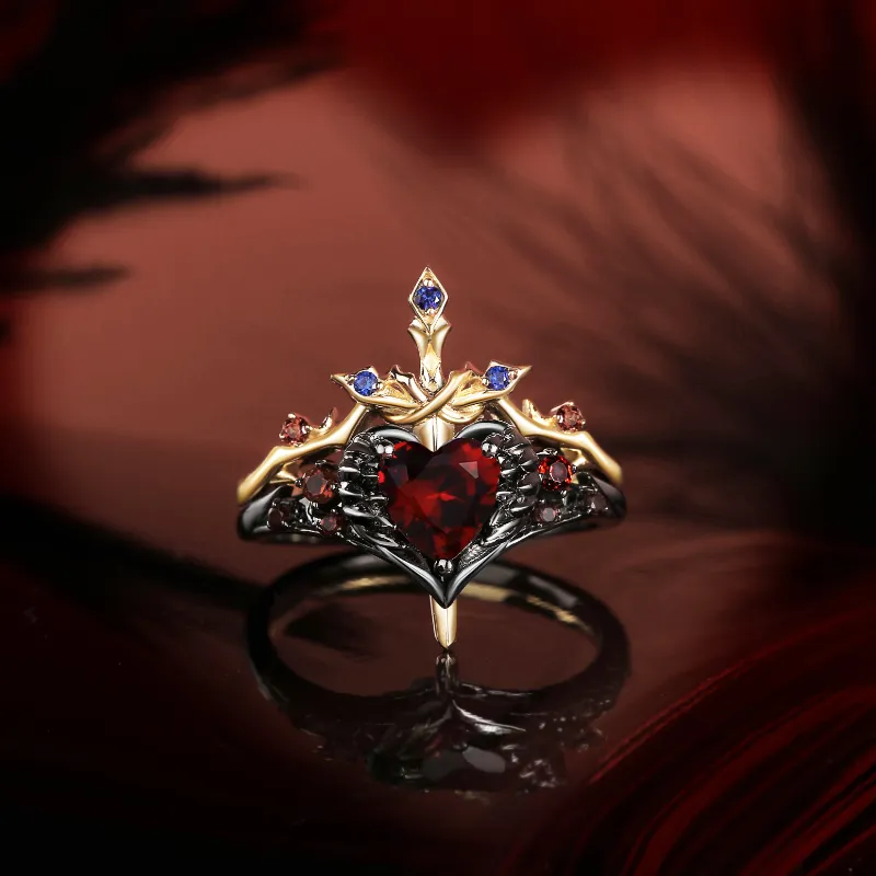 Starlandus Pierced Heart Gothic Style Garnet Heart Sword Ring Two-Tone Bridal Set showing feather wrapped heart ring with matching thorn det