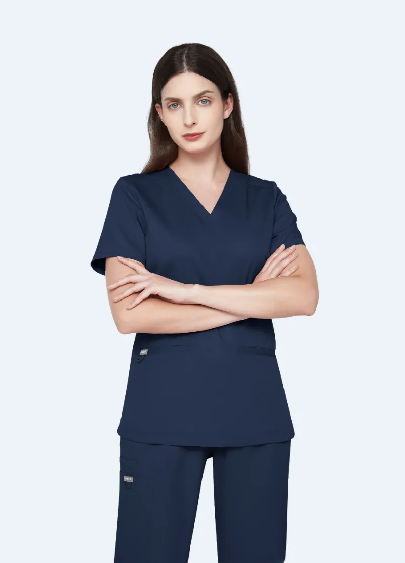 COMENII SoftTouch Essential Scrub Top in Midnight Navy, front view showing tailored fit and welt pockets