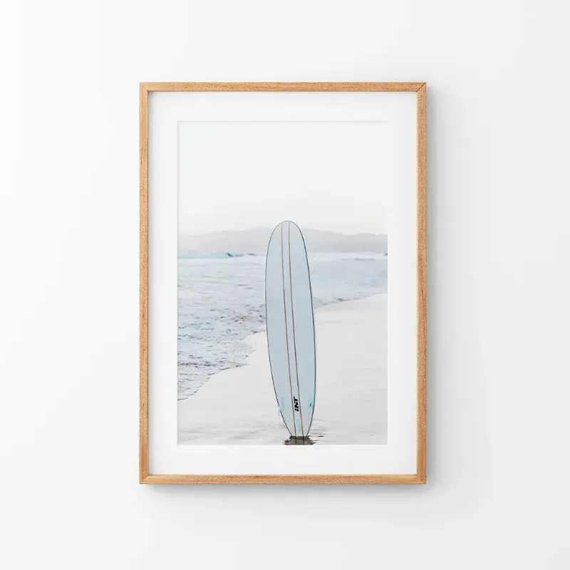 Wall Art Set Blue Surfboard Print Ocean Beach Wall Art showing blue surfboard on sandy California beach