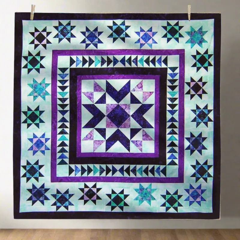 Boho Blanket Floating Stars Quilt Pattern showing a bold star quilt in layered colours