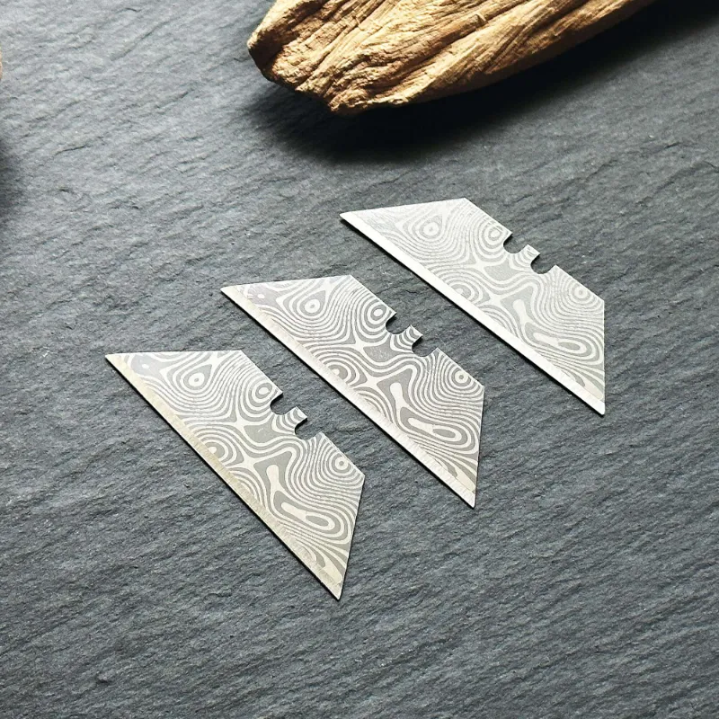 The Stinger Tools Stinger laser engraved utility razor blades Damascus style trapezoid 3 pack silver