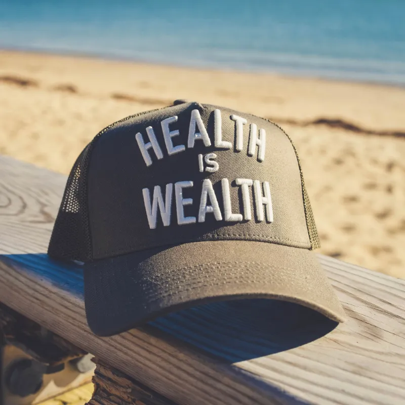 Find The Good Brand Health Is Wealth Trucker Hat with embroidered mental health message and mesh back