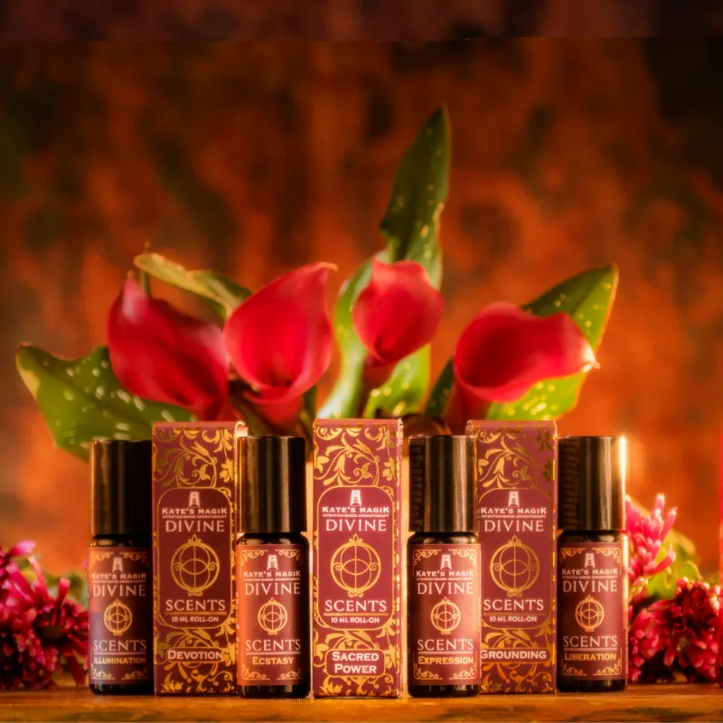 Kates Magik Divine Scents Complete Collection showing all seven chakra roll-on perfumes in violet glass