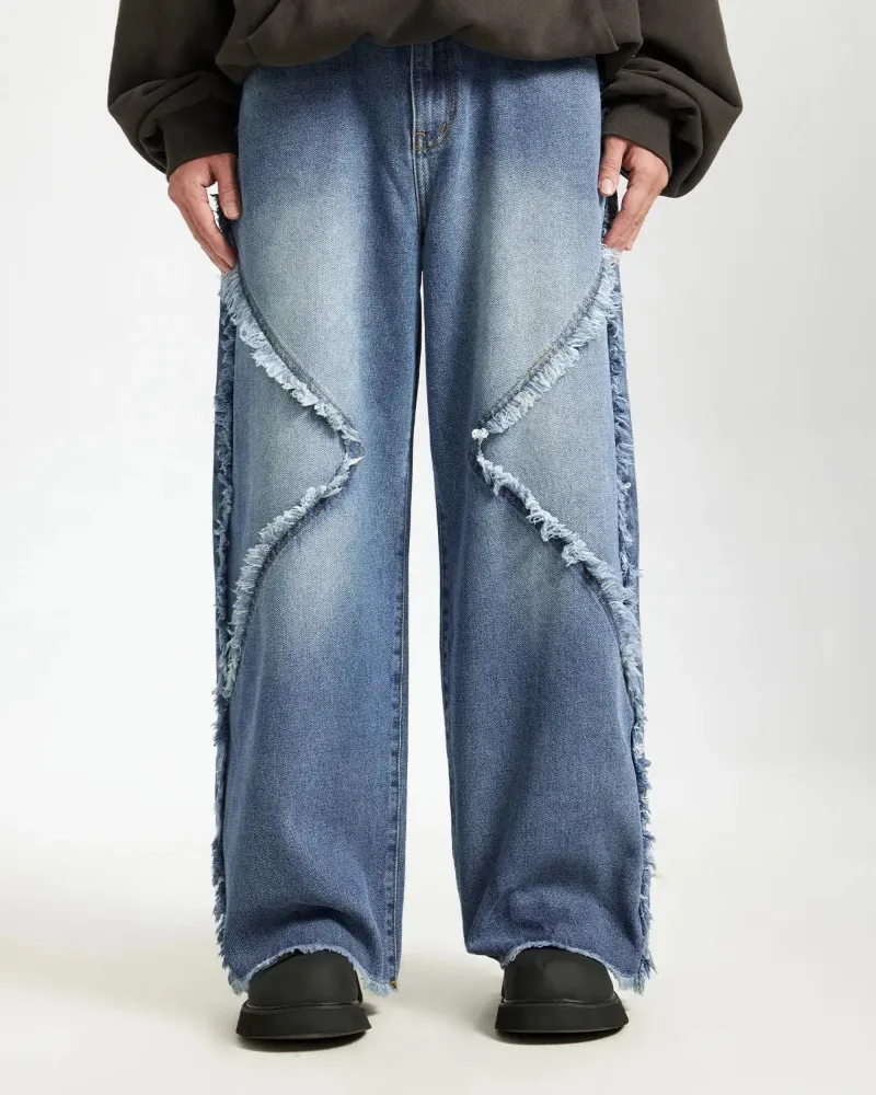 INFLATION Blue Frayed Acid Wash Pants in loose fit medium wash denim with zipper fly