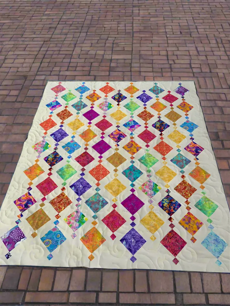 Boho Blanket Love Melody Quilt Pattern, a quilt with bold tree-ring-inspired blocks layered in prints and solids