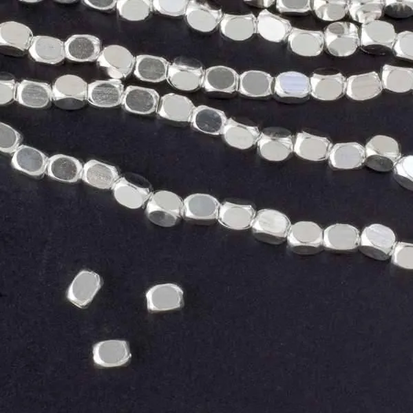 Cherry Tree Beads Silver Plated Brass 3x4mm Faceted Pillow beads, a full strand laid out flat