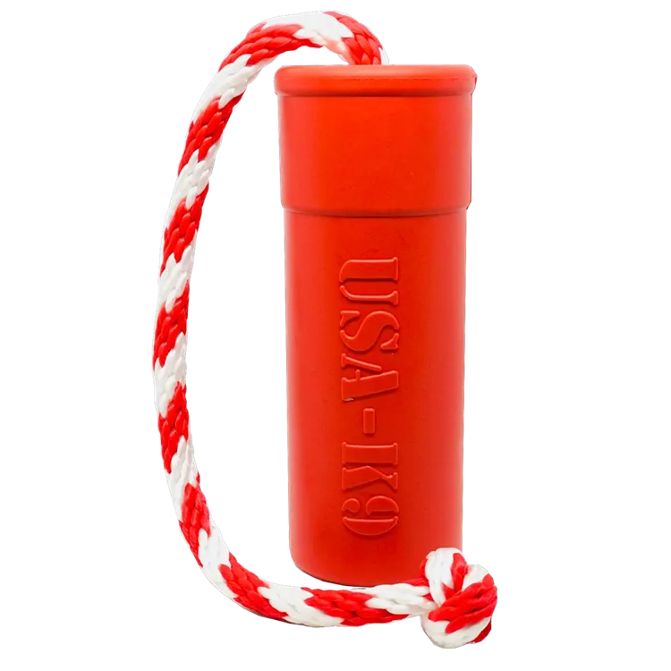 Soda Pup USA-K9 Firecracker Floating Training Dummy red rubber toy on grass near water
