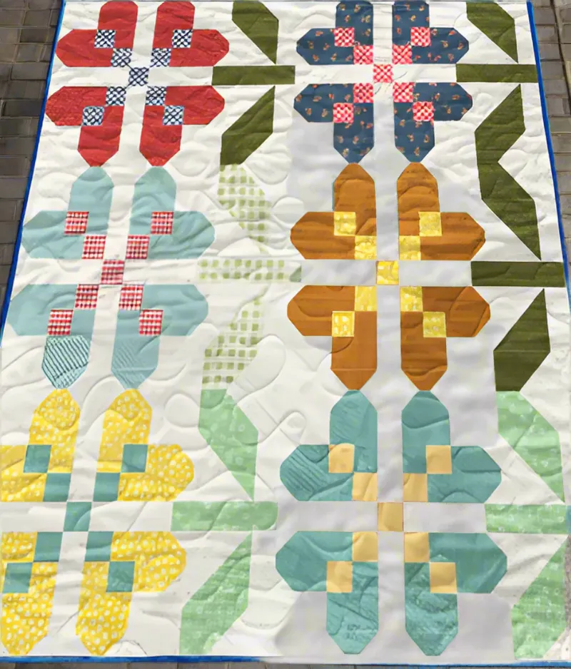 Boho Blanket Petal Pathways Quilt Pattern, a lap-size quilt with layered petal-inspired design